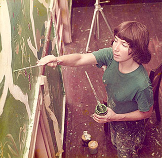 Ann Turley Painting a Mural in a Public School.